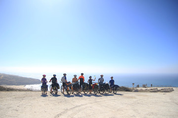Team of bikers are looking at the Atlantic ocean in Portugal