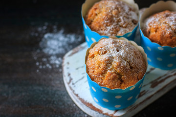 Muffins, cakes with almond nuts on a dark background. Copy space.