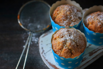 Muffins, cakes with almond nuts on a dark background. Copy space.