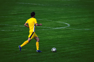 Running with a ball soccer player.
