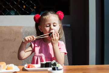 little girl eating sushi chopsticks © Stanislaw Mikulski