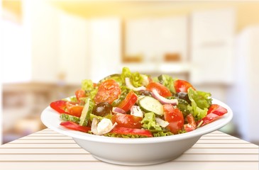 Close-up photo of fresh salad with vegetables in white plate