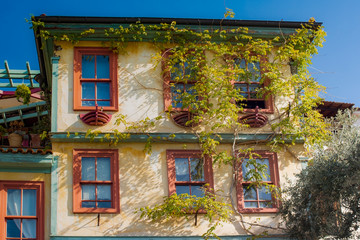 Fototapeta na wymiar The architecture of Kavala - a beautiful house with climbing plants in the old town. Greece.