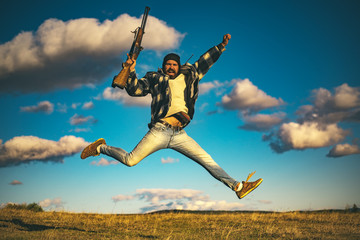 Hunter with shotgun gun on hunt. Crazy hunter on sky background.