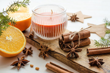 Obraz na płótnie Canvas oranges with anisestars, cinnamon sticks, juniper branch and candle