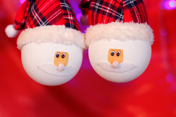 Two snowmans on a red background