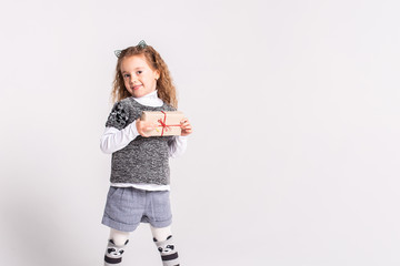 a girl on a white background with a small gift