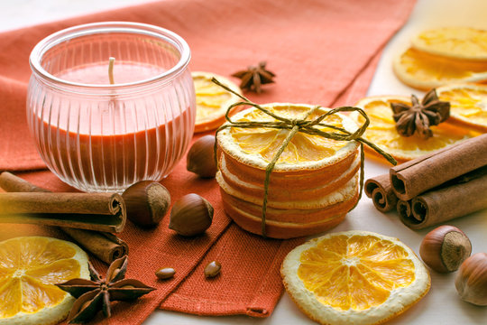 dried oranges, anise stars, filbert nuts, cinnamon sticks and candle