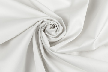 White sateen fabric is draped with diagonal folds in the form of a spiral