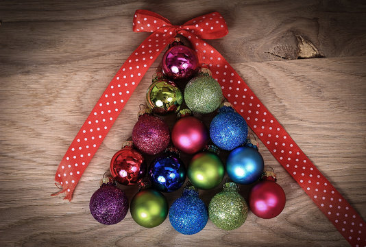 colorful Christmas balls stacked in triangle shape