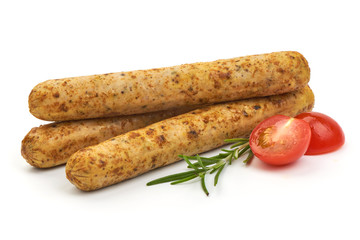 German Spicy Sausages with herbs and tomatoes, isolated on a white background. Close-up.