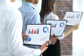 closeup.business team keeps files of financial graphs