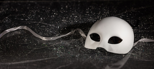 Carnival mask white on black shiny background