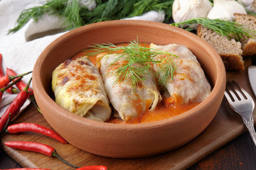 Stuffed cabbage leaves in tomato sauce on plate