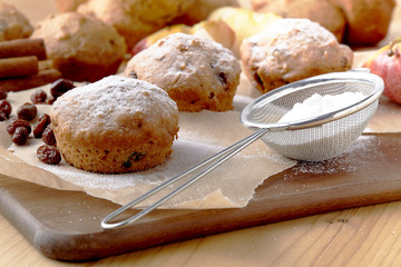 Traditional German Christmas pastry mini stollen on parchment paper on plank wood table