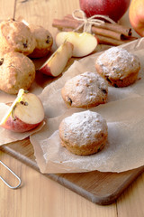 Traditional German Christmas pastry mini stollen on parchment paper on plank wood table