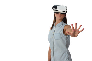  Young woman in virtual reality (VR) glasses holding tablet. Isolated on white background