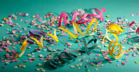 Carnival or birthday party, confetti and serpentines on bright green background