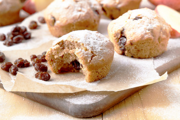 Traditional German Christmas pastry mini stollen on parchment paper on plank wood table