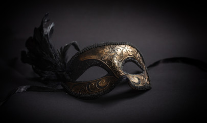 Carnival mask with feathers on black background