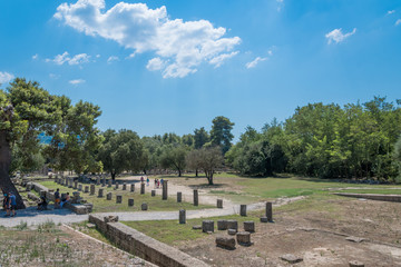 Tourists visiting archaeological site of Olympia in Peloponnese Greece.  In antiquity the Olympic Games were hosted every four years in Olympia from 776 BC