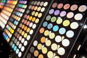 Eye shadow black palettes. Big choice of different hues and colors. Makeup store.