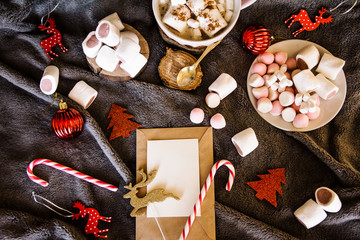 Obraz na płótnie Canvas Good New Year spirit. Coffee with marshmallows and cinnamon. Pink mug. Cooking yourself. Home comfort. New Year. Christmas time. Winter mood.Letter to Santa Claus. To Do list. New Year resolution