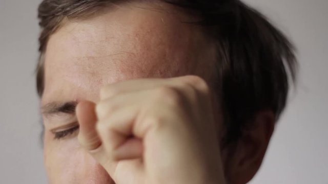 Showing a magic trick with his eyeball after looking through the hole.
