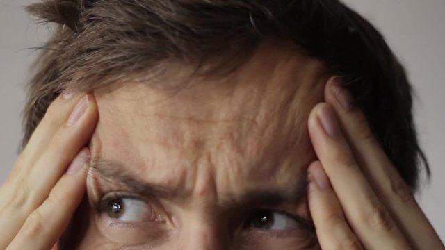 Young man have a headache.