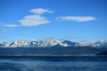 Fototapeta na wymiar Ushuaia, the southernmost city in the world with snow covered mountain range in backdrop view from cruise ship on Beagle channel, Ushuaia, Tierra del Fuego, Argentina