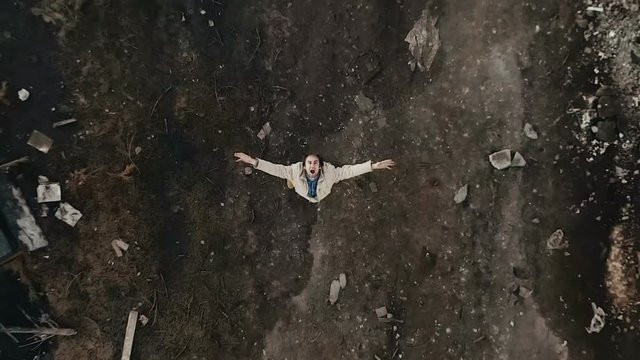 4k aerial view. Scream and panic of a man in an abandoned location, hopelessness and supplication for help