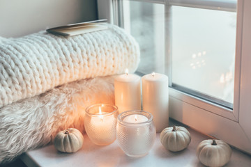 Hygge scene with sweater and candles