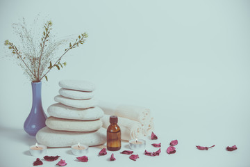 Spa still life with towels, stones, bath oil and candle