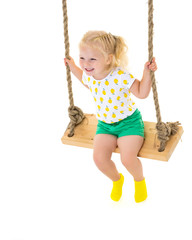 Little girl swinging on a swing