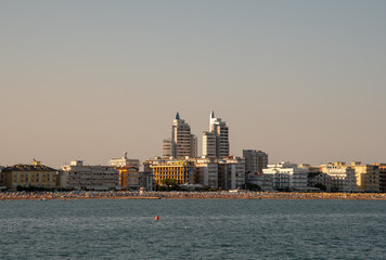Obraz premium Coast city with skyscrapers and beach on the sea at sunset, Jesolo Lido, Venice, Italy