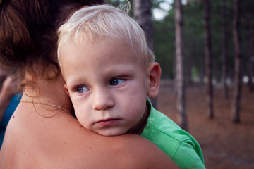 beautiful little boy at mom's arms