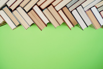 Many Books Piles. Hardback books on wooden table. Back to school.