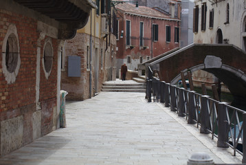 Fototapeta premium Old man walking up road near canal in Venice on April 5, 2018 (5072)
