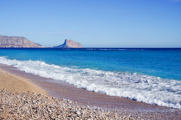 View to calm sea and shingle beach