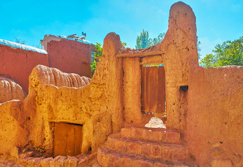 Preserved medieval gate of red clay leads to the tiny private garden, Abyaneh village, Iran.