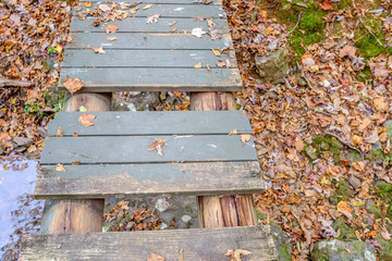 wooden bridge in autumn with missing treads