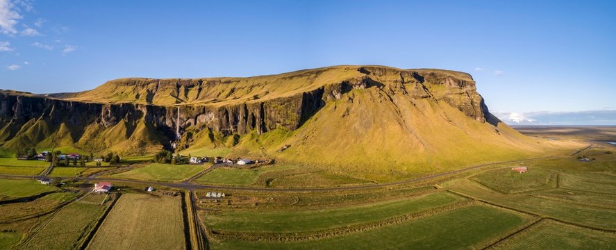 Drone shot, Foss a Sidu waterfall and Dverghamrar stone flank, Iceland, Europe