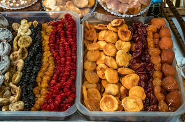 Exhibited in plastic trays candied apricots, peaches, figs,prunes, yellow and red cherries
