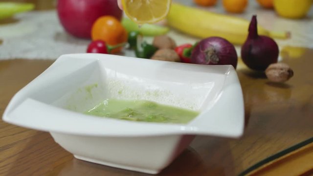 Female Hands Squeezing Lemon Making Guacamole Salad With Avocado.