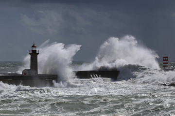 Fototapeta na wymiar Big storm with big waves near a lighthouse