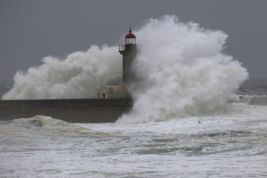 Big storm with big waves near a lighthouse