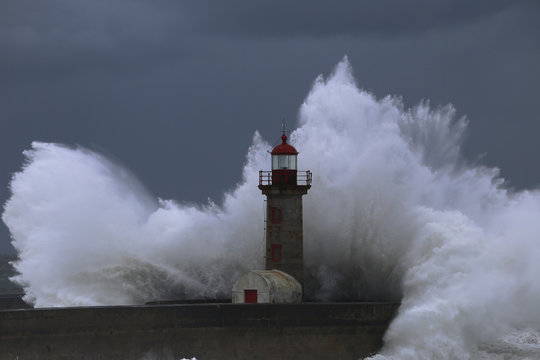 Big storm with big waves near a lighthouse