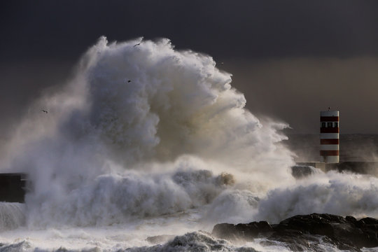 Big storm with big waves near a lighthouse