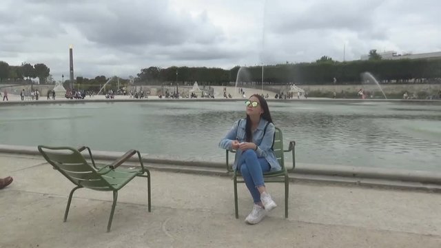 Girl, sat down and looking around, Paris, France