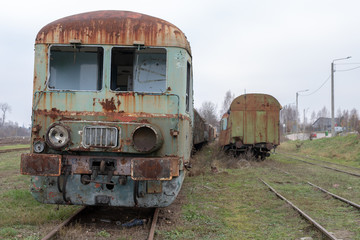 Fototapeta na wymiar Old destroyed locomotives. Forgotten railway station in central europe.